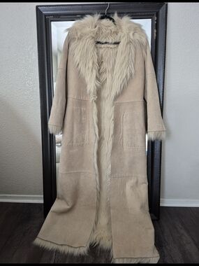 Beige Long Leather Coat With Faux Fur Trim Along Collar, Cuffs And Interior.